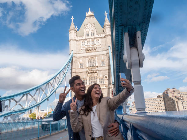 istock Diverse couple taking selfie in London with the Tower bridge 1448090272