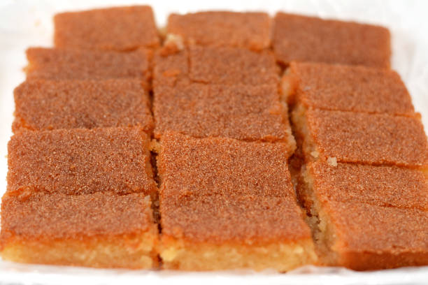 istock Plain basbosa or basbusa cut into pieces with honey sugary syrup on it, Basbusa is a middle eastern dessert that is usually baked in Ramadan month, Arabian sweet cuisine background 1448091534