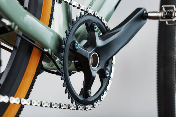 The leading star of a bicycle with a connecting rod and a chain close-up The leading star of a bicycle with a connecting rod and a chain close-up, accessories for repair and tuning chainring stock pictures, royalty-free photos & images