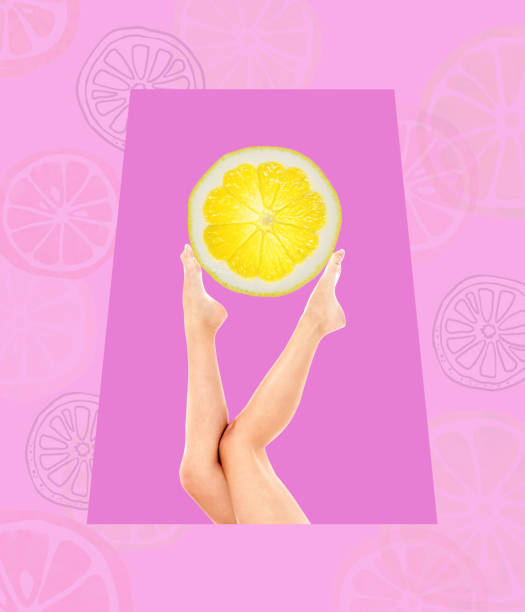 istock Legs holding a slice of orange. 1448093749
