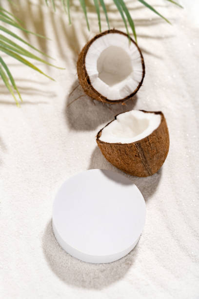 Coconut beauty skincare scene for cosmetic product presentation. Mockup round scene on a sand, view above. Vertical photography. stock photo
