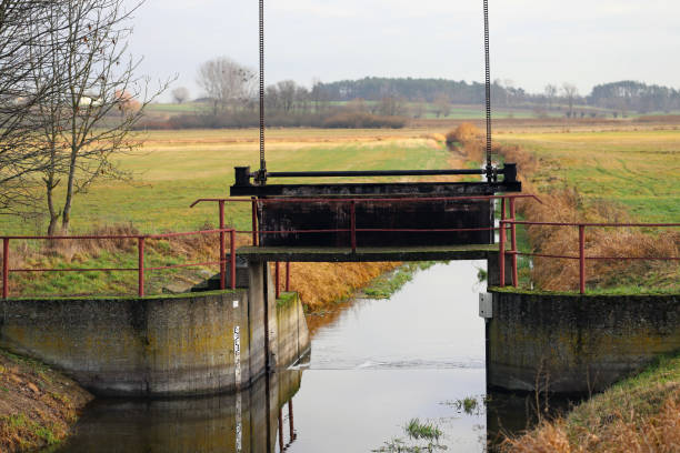 istock Storm water runoff flowing from drainage ditch into concrete culverts on the meadows. 1448099700