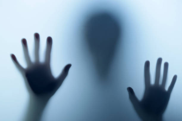 istock Blurred shadow in blue light outside the door. The concept of nightmares, ghosts, horror, paranormal 1448100548