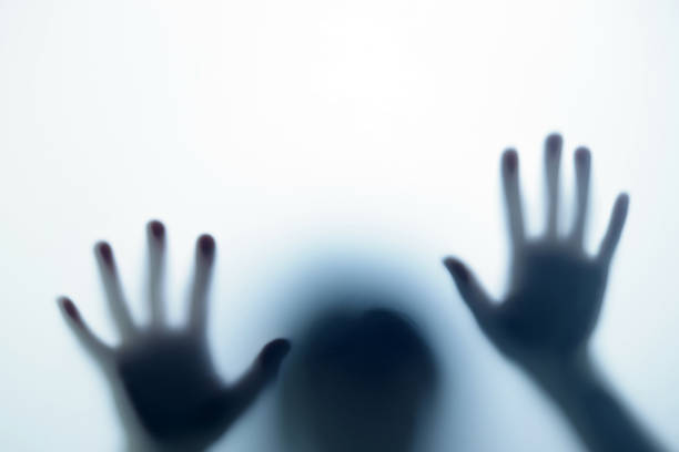 istock Blurred shadow in blue light outside the door. The concept of nightmares, ghosts, horror, paranormal 1448100549
