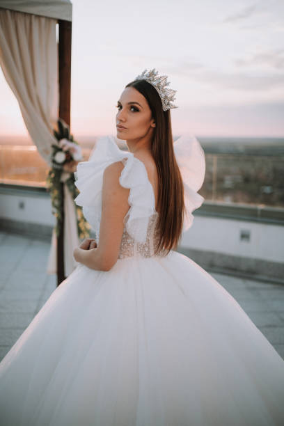 istock Beautiful bride posing in white princess dress with crown. 1448102726