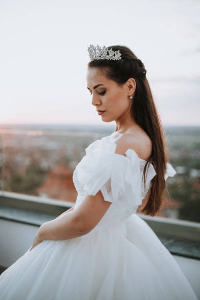 istock Beautiful bride posing in white princess dress with crown. 1448102778