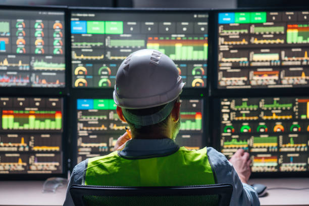 istock Industry 4.0. Head engineer control production line with computer screens. Factory operator following assembly process uses human-machine interface 1448103771