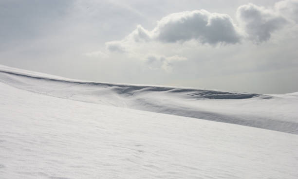 istock a small cloud above an expanse of snow 1448103803