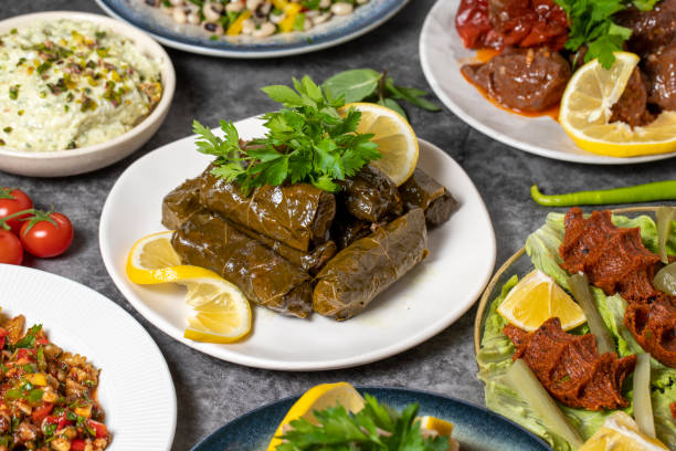 istock Traditional Turkish and Greek dinner appetizer table. Mediterranean appetizer concept. Dry cowpea salad, roasted eggplant salad, stuffed leaves with olive oil, stuffed dried peppers, cabbage rolls 1448104121