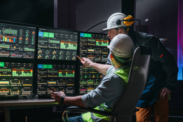 istock Couple of operators control process on product line uses Industry 4.0 and digital technology on modern factory. Two engineers follow assembly process uses SCADA system which modern technology 1448105173