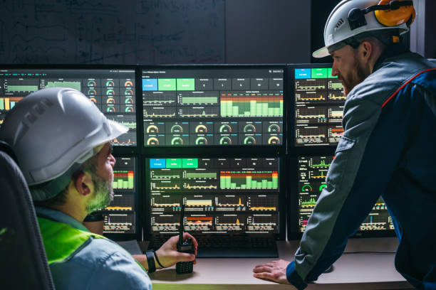 istock Couple of operators control process on product line uses Industry 4.0 and digital technology on modern factory. Two engineers follow assembly process uses SCADA system which modern technology 1448105404