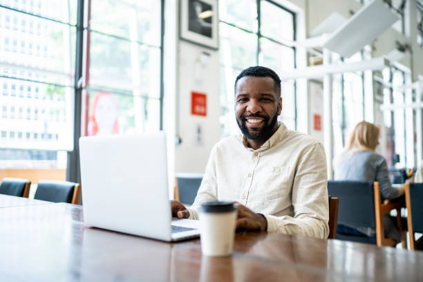 istock Portrait of a man using laptop in a library 1448106545