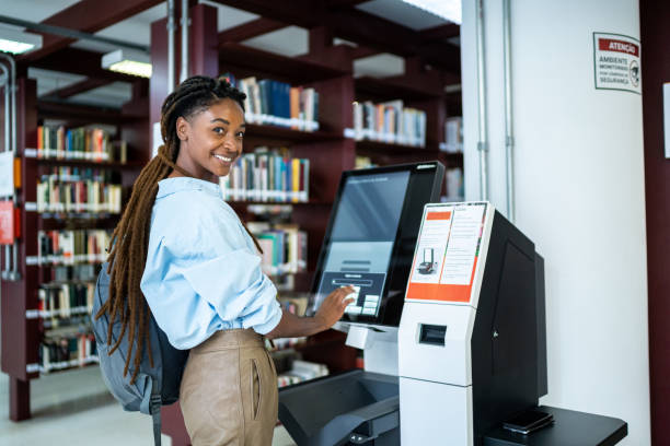 istock Portrait of a student searching for a book in the library system 1448108152