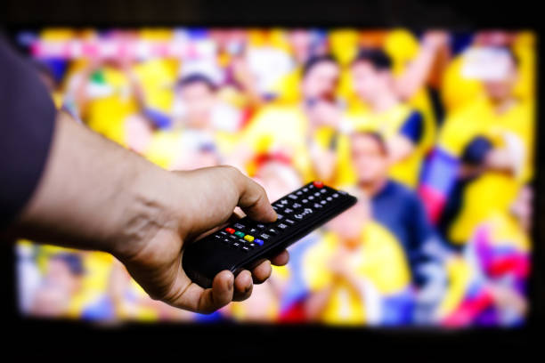 istock Watching soccer with TV remote control in hand 1448109235
