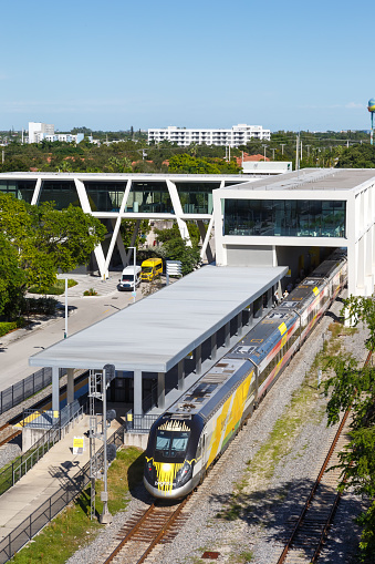 Fort Lauderdale, United States - November 13, 2022: Brightline private inter-city rail train at Fort Lauderdale railway station portrait format in Florida, United States.
