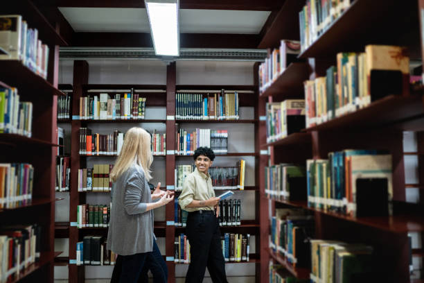 istock Female students walking in the library 1448115880