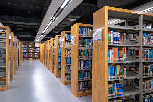Bookcases on the aisle of the library in the University of Fujian Province, China