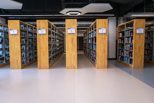 Bookshelves inside the library of Fujian University, rows of books