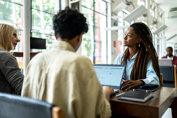 istock Friends studying in the library 1448117071
