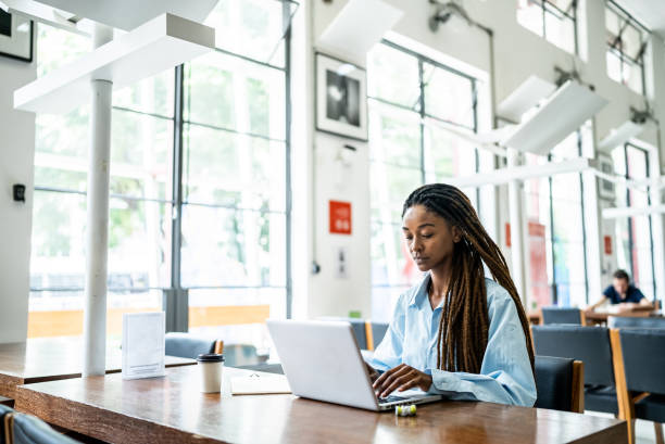 istock Young woman using the laptop in the library 1448117639