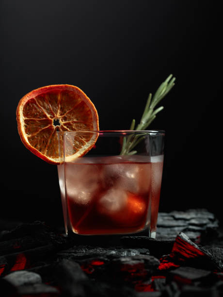 istock Old-fashioned cocktail with whiskey, ice, orange, and rosemary. 1448117784