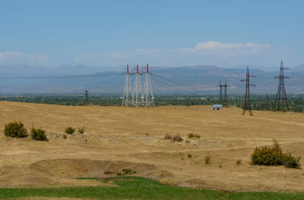 istock Power line in the valley along the forested mountains. 1448117883