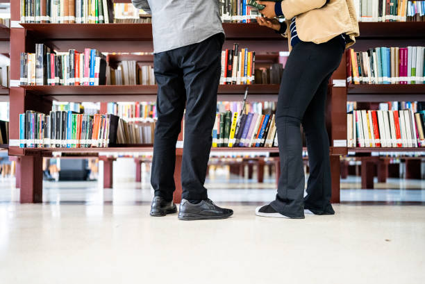 istock Low section of friends in the library 1448121439