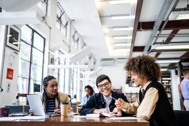 istock Friends studying in the library - including a transgender person 1448121516