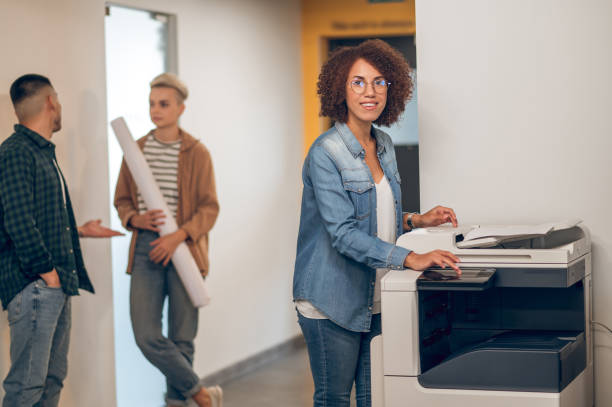 istock Experienced secretary making document copies on the photocopier 1448121684