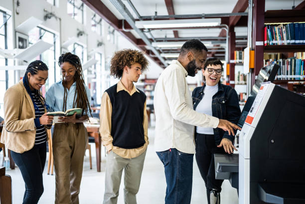 istock Friends using the self checkout to borrow books from the library - including a transgender person 1448121933