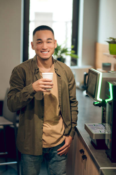 istock Office worker enjoying his coffee break in the office kitchen 1448122588