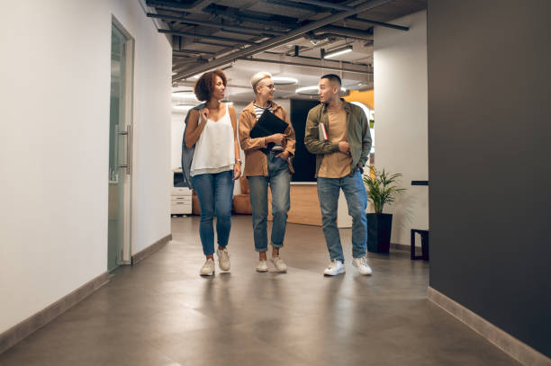 istock Office workers having a conversation in the company corridor 1448122679