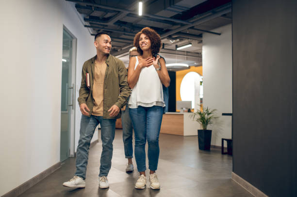 istock Cheerful office worker courting his joyous coworker 1448122681