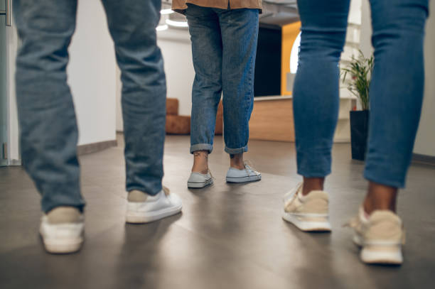 istock Company of three in a well-lit hallway 1448122707