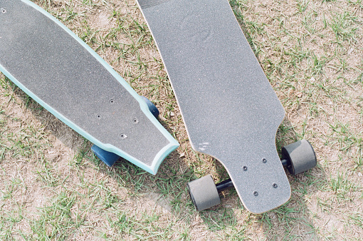 Cruiser Skateboards on the Grass During Picnic, Taken with Film Camera