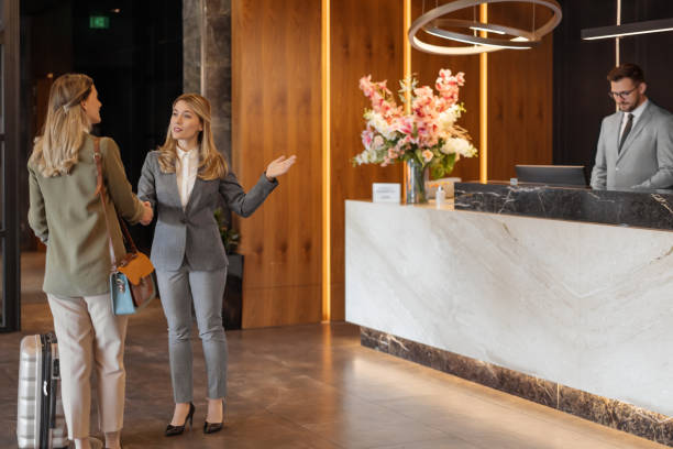 istock Hotel manager and guest making handshake 1448123110