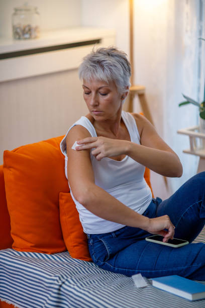 istock Mature Woman Applies Transdermal Patch 1448124081