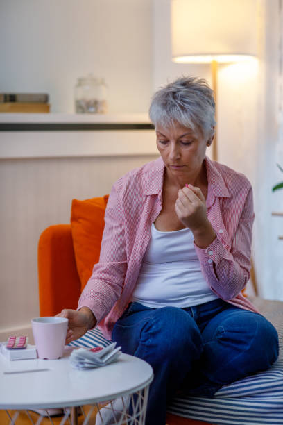 istock Mature Woman Taking Pill 1448124091