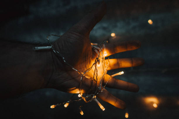 istock Hand with fairy lights 1448124405