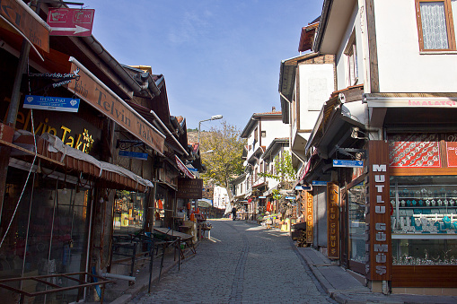 Ankara, Turkey - November 28, 2022: People and sellers are on the narrow ottoman roads and you see rustic houses of Beypazarı-Ankara Turkey. Overview of Beypazarı from Hıdırlık Hill. Beypazarı is a Turkish town and district of Ankara Province in the Central Anatolia region of Turkey, approximately 100 km west of the city of Ankara. Beypazari is famous at carrot product and mineral water productions.