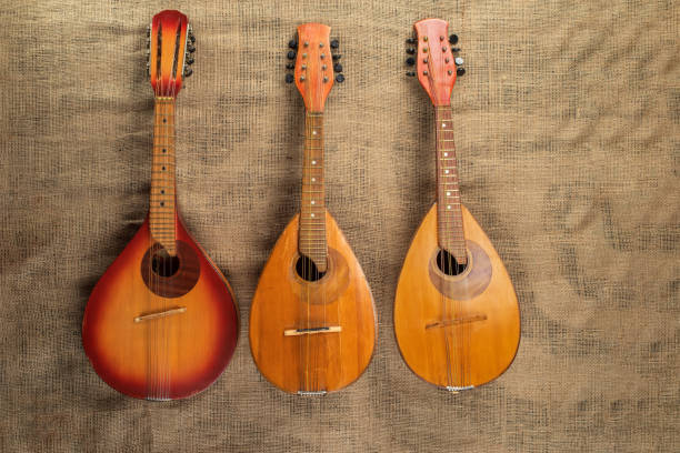 istock Three old mandolins on a background of rough burlap t 1448126530