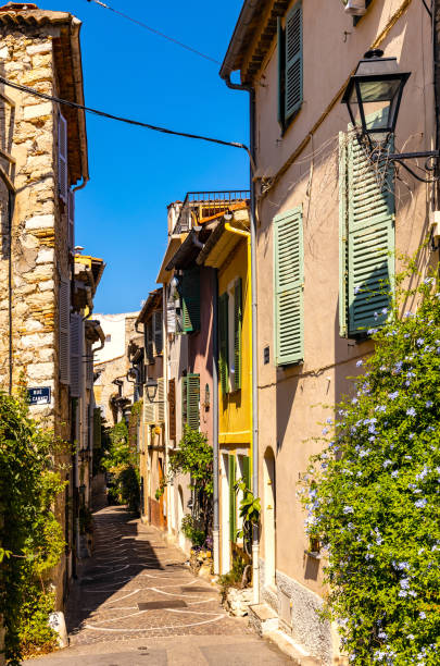 Rue des Revennes street with colorful vintage houses in historic old town of Antibes city onshore Mediterranean Sea in France stock photo