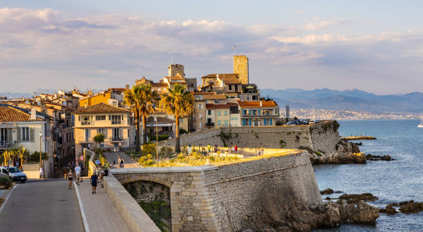 Historic old town with medieval city walls and Picasso Museum onshore Mediterranean Sea in Antibes in France stock photo