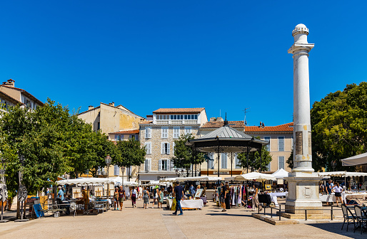 Antibes, France - August 4, 2022: Place Nationale National Market Square with Independence Column in historic old town of Antibes resort city onshore Azure Coast of Mediterranean Sea