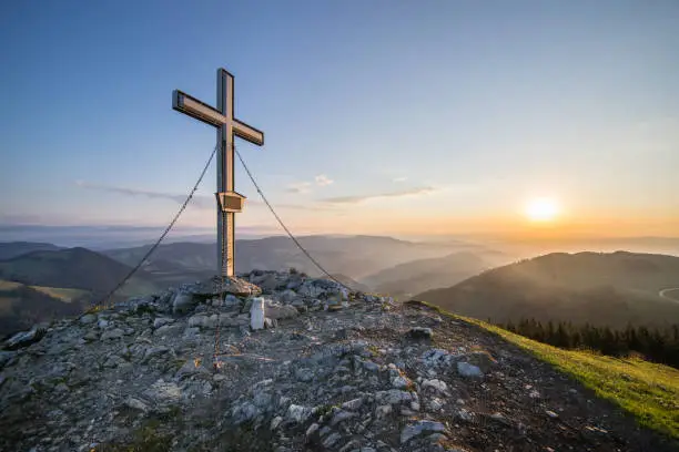 The summit cross at the Plankogel in Styria, Austria on an early summer morning