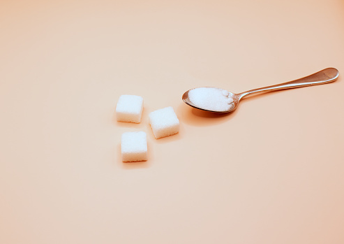 Top view of white bowl full of sugar cubes