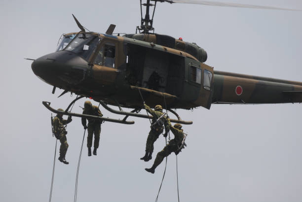 japan ground self-defense force air assault demonstration. - color image people air vehicle airplane imagens e fotografias de stock