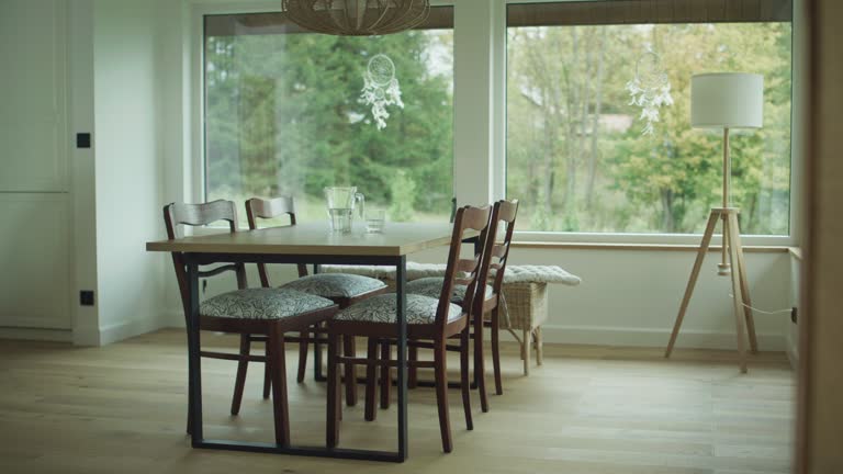 Interior of a modern dining room in a high-end apartment with large windows