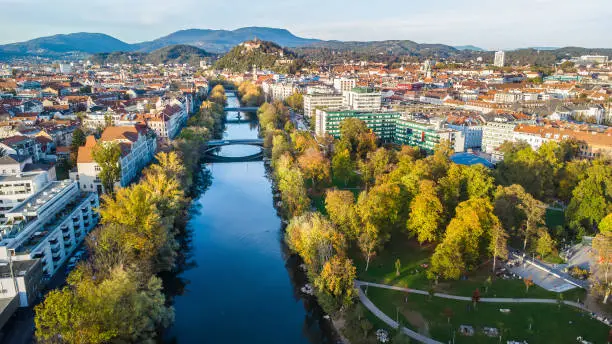 Aerial view of the city of Graz during autumn with the beautiful river Mur and the new Augartenbucht in the municipal park
