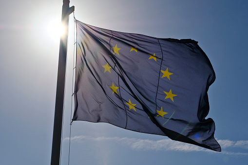 European Union flag fluttering against blue sky
